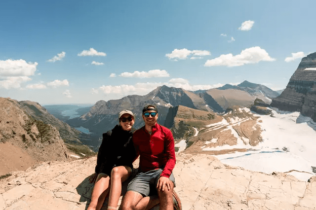 Shannon and Cole sitting together in the mountains
