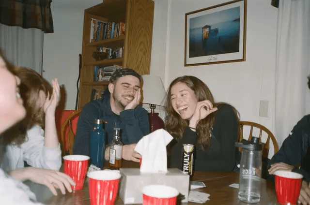 Shannon and Cole laughing around a table